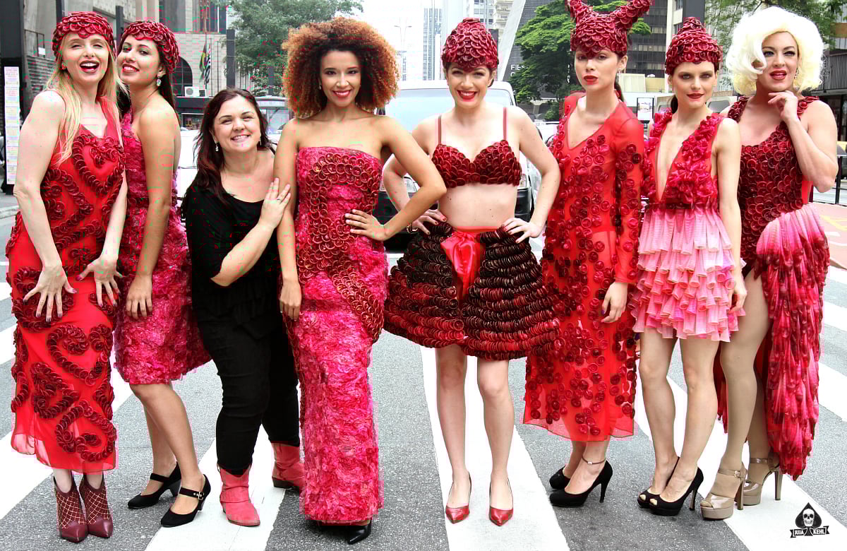 Brazilian artist Adriana Bertini posing with models with her condom dresses